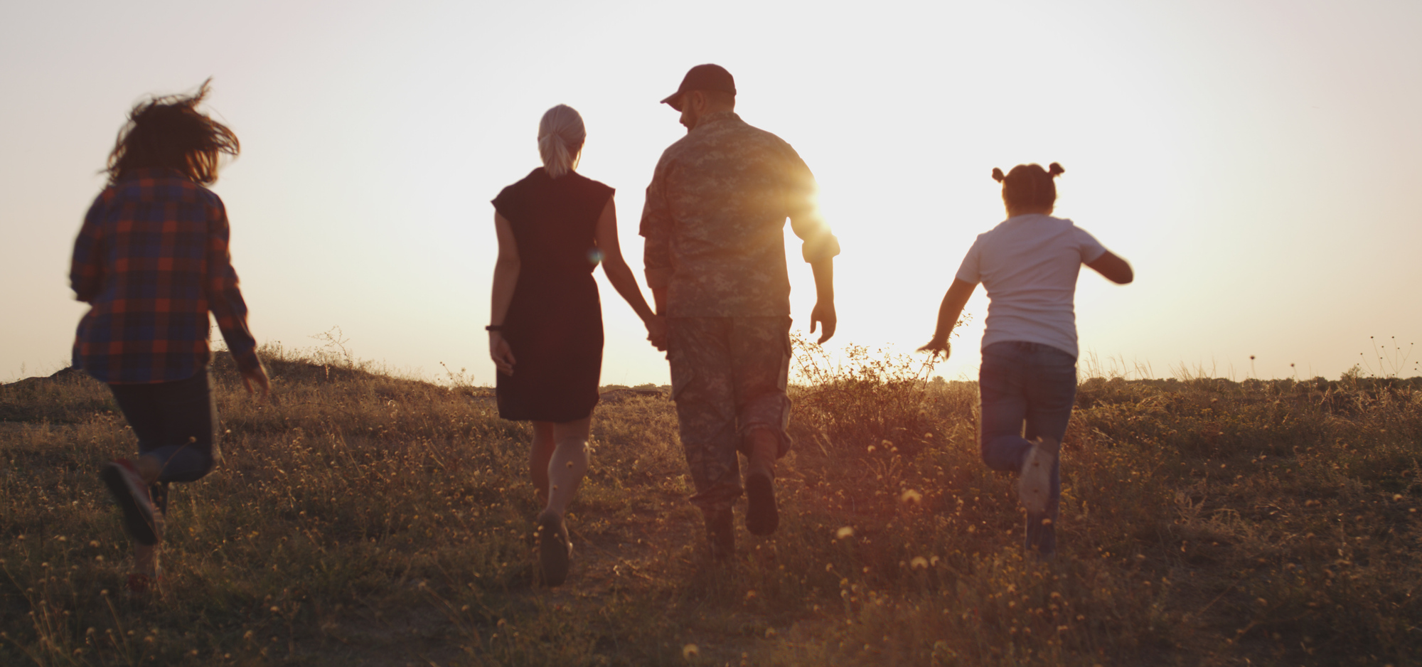 Soldier and his family walking on a meadow
