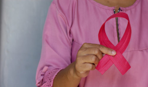 Woman holding a pink ribbon